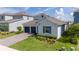 Beautiful single-Gathering home featuring a brick-paved driveway, two-car garage, and lush green lawn at 2591 Seagirt Way, Clermont, FL 34711