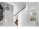 Bright hallway with stairs and light fixtures at 2591 Seagirt Way, Clermont, FL 34711