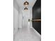 Hallway with neutral colors, tile floor and a view towards the backyard at 2591 Seagirt Way, Clermont, FL 34711