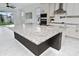 Kitchen island featuring a granite countertop, ample space and an undermount sink at 2591 Seagirt Way, Clermont, FL 34711