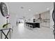 Open-concept kitchen boasts a large island with seating and stainless steel appliances at 2591 Seagirt Way, Clermont, FL 34711