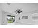 Living room featuring a fan and access to a patio at 2591 Seagirt Way, Clermont, FL 34711
