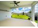 Covered patio features a ceiling fan and a view of the spacious backyard at 2591 Seagirt Way, Clermont, FL 34711
