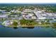 An aerial view of a lakeside city with greenery and buildings, providing a picturesque panorama at 2623 Gables Dr, Eustis, FL 32726