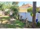A backyard area with seating, surrounded by a white fence and mature trees at 2623 Gables Dr, Eustis, FL 32726