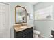 This traditional bathroom features a toilet, window, and a nice granite sink at 2623 Gables Dr, Eustis, FL 32726