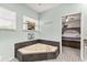 Bright bathroom with a triangular tub and an ornate tile floor at 2623 Gables Dr, Eustis, FL 32726