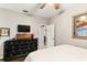 The bedroom has a ceiling fan, TV and nice natural lighting at 2623 Gables Dr, Eustis, FL 32726