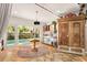 Bright bonus room with views of the pool, unique lighting, and a vintage armoire at 2623 Gables Dr, Eustis, FL 32726