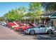 A line of classic cars parked on a brick street, showcasing their beauty and character at 2623 Gables Dr, Eustis, FL 32726
