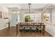 Bright dining area with a rustic wood table, chandelier, and an inviting view of the home's entrance at 2623 Gables Dr, Eustis, FL 32726