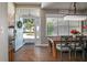 View into home showcasing dining area, chandelier and open door, revealing the well-maintained front yard at 2623 Gables Dr, Eustis, FL 32726