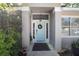 Close-up of the front door, featuring a wreath, sidelights, and the house number above, framed by greenery at 2623 Gables Dr, Eustis, FL 32726