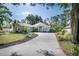 Charming single-story home with lush landscaping, a welcoming driveway, and a delightful light blue front door at 2623 Gables Dr, Eustis, FL 32726