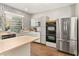Stylish kitchen featuring stainless steel appliances, patterned backsplash, and plenty of cabinet space at 2623 Gables Dr, Eustis, FL 32726