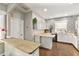 Bright kitchen featuring white cabinets, a modern countertop, patterned wallpaper, and lots of natural light at 2623 Gables Dr, Eustis, FL 32726