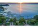 Scenic view of a lake at sunset, with water lilies and a park along the shoreline at 2623 Gables Dr, Eustis, FL 32726