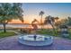 Lakefront view of a city park with a statue and fountain and sunset at 2623 Gables Dr, Eustis, FL 32726