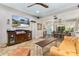 Open-concept living room with ample seating, entertainment center, and access to other parts of the home at 2623 Gables Dr, Eustis, FL 32726