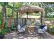 Relaxing outdoor patio featuring a tiki umbrella and outdoor seating at 2623 Gables Dr, Eustis, FL 32726
