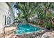 Beautiful backyard pool surrounded by lush plants and a patio at 2623 Gables Dr, Eustis, FL 32726