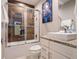 Modern bathroom features stylish wood-look shower with glass doors, granite vanity and square vessel sink at 2660 Sunrise Shores Dr, Kissimmee, FL 34747