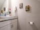 This bathroom offers a modern vanity with granite countertop and fun superhero-themed decor at 2660 Sunrise Shores Dr, Kissimmee, FL 34747