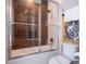 Bathroom featuring a glass shower door with dark wood-look tile surround and a Hogwarts Hufflepuff banner at 2660 Sunrise Shores Dr, Kissimmee, FL 34747