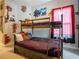 Fun bedroom with a bunk bed, Harry Potter themed decor, and faux brick accents at 2660 Sunrise Shores Dr, Kissimmee, FL 34747