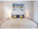 Comfortable bedroom featuring a padded headboard, matching nightstands, and soft, neutral colors at 2660 Sunrise Shores Dr, Kissimmee, FL 34747