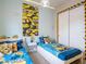 This cheerful bedroom includes twin beds, fun Minions decor, and a closet at 2660 Sunrise Shores Dr, Kissimmee, FL 34747