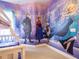 Charming ' bedroom featuring a 'Frozen' theme with character wall art and bunk beds at 2660 Sunrise Shores Dr, Kissimmee, FL 34747