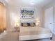 Comfortable bedroom featuring a padded headboard, matching nightstands, and soft, neutral colors at 2660 Sunrise Shores Dr, Kissimmee, FL 34747