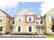Bright exterior of a multi-unit townhouse with white trim and inviting curb appeal at 2660 Sunrise Shores Dr, Kissimmee, FL 34747