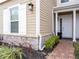 Attractive home featuring a stone base, a manicured lawn, and classic detailing at 2660 Sunrise Shores Dr, Kissimmee, FL 34747