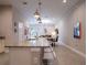 Open kitchen with granite countertops, stainless steel appliances, and a view to the dining area at 2660 Sunrise Shores Dr, Kissimmee, FL 34747