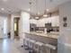 Well-lit kitchen featuring granite countertops, stainless steel appliances, and bar seating at 2660 Sunrise Shores Dr, Kissimmee, FL 34747