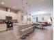 Open-concept kitchen with granite countertops, stainless steel appliances, and island seating at 2660 Sunrise Shores Dr, Kissimmee, FL 34747