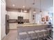 Kitchen with granite countertops, stainless steel appliances, and island seating at 2660 Sunrise Shores Dr, Kissimmee, FL 34747