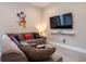This playful living room includes a cozy sectional sofa, large TV, and fun character accents at 2660 Sunrise Shores Dr, Kissimmee, FL 34747