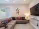 Fun living room features a large sectional sofa, tile floors, and whimsical decor at 2660 Sunrise Shores Dr, Kissimmee, FL 34747
