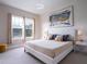 Comfortable main bedroom with natural light, a king bed, and abstract artwork at 2660 Sunrise Shores Dr, Kissimmee, FL 34747