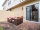 Charming outdoor patio featuring wicker seating and a small dining table at 2660 Sunrise Shores Dr, Kissimmee, FL 34747