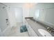 Bathroom with double sinks, white cabinets, tile floors, tub and shower combo and lots of counter space at 3027 Addison Blvd, St Cloud, FL 34771