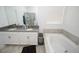 Bright bathroom with double sinks, a soaking tub, and elegant finishes at 3027 Addison Blvd, St Cloud, FL 34771