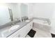 Elegant bathroom with double vanity, soaking tub, and modern fixtures at 3027 Addison Blvd, St Cloud, FL 34771