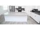 Modern kitchen featuring a large island, stainless appliances, and sleek finishes at 3027 Addison Blvd, St Cloud, FL 34771