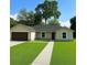 Charming one-story home featuring a well-manicured lawn and inviting entrance at 3082 Se 140Th Ln, Summerfield, FL 34491