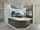 Modern kitchen featuring an island, stainless steel appliances, white cabinets and pendant lighting at 3082 Se 140Th Ln, Summerfield, FL 34491