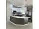 Modern kitchen featuring an island, stainless steel appliances, white cabinets and pendant lighting at 3082 Se 140Th Ln, Summerfield, FL 34491
